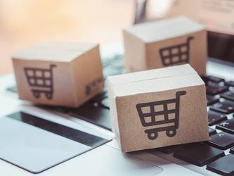 online shopping boxes on top of laptop